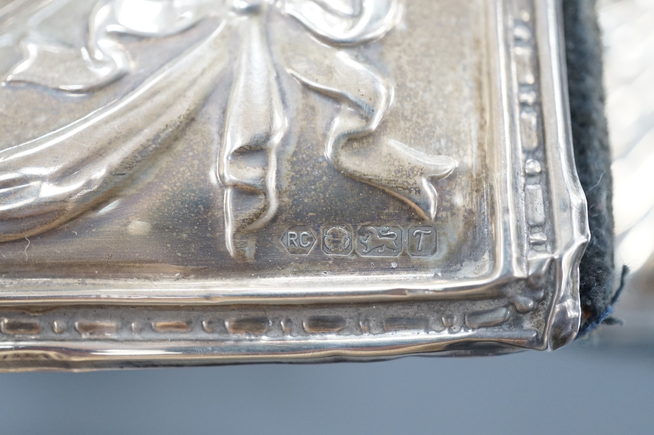A modern silver mounted desk timepiece, 15.2cm and two mounted photograph frames, including Italian 925 and Edwardian repousse.